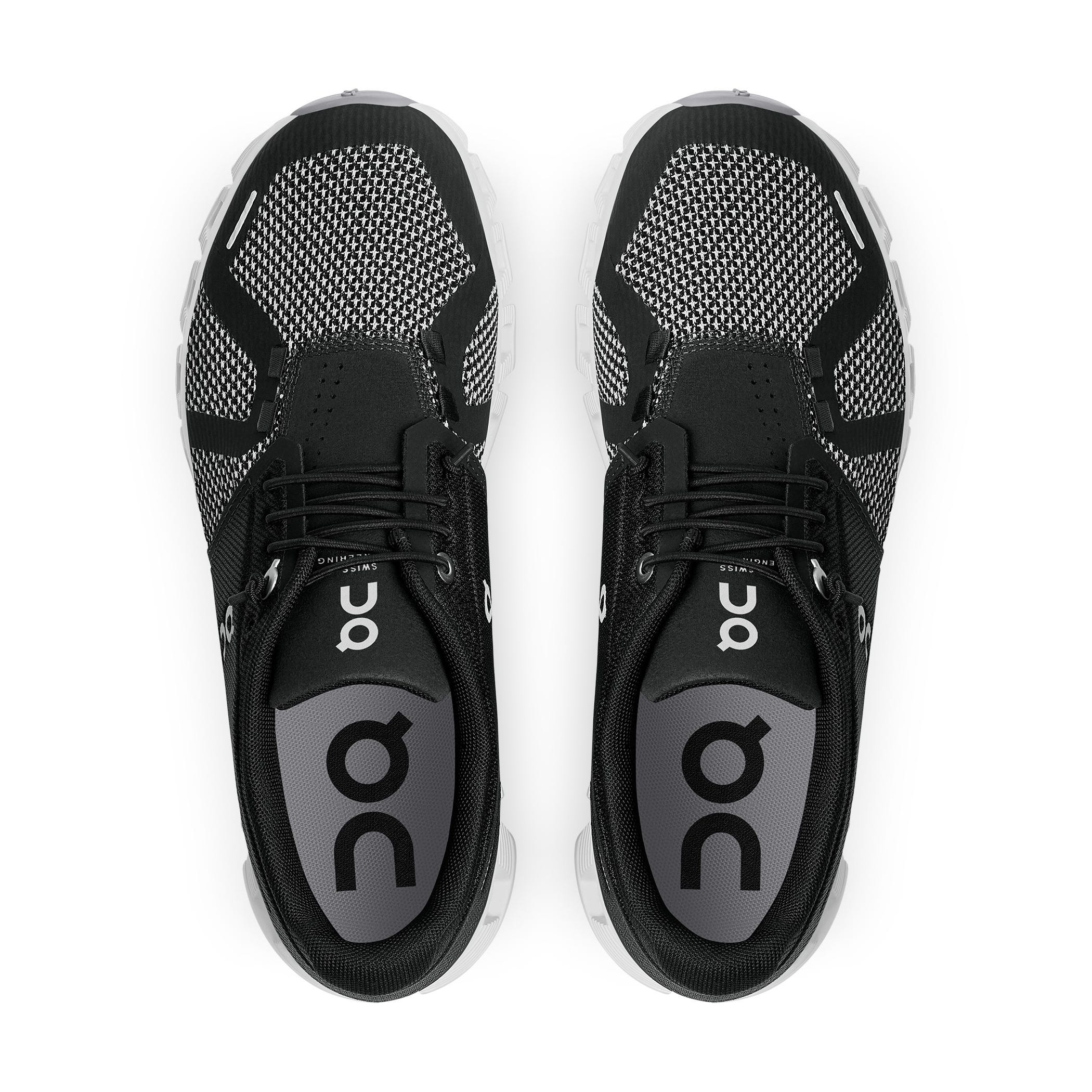 A pair of black and white athletic running shoes with lace-up fronts.