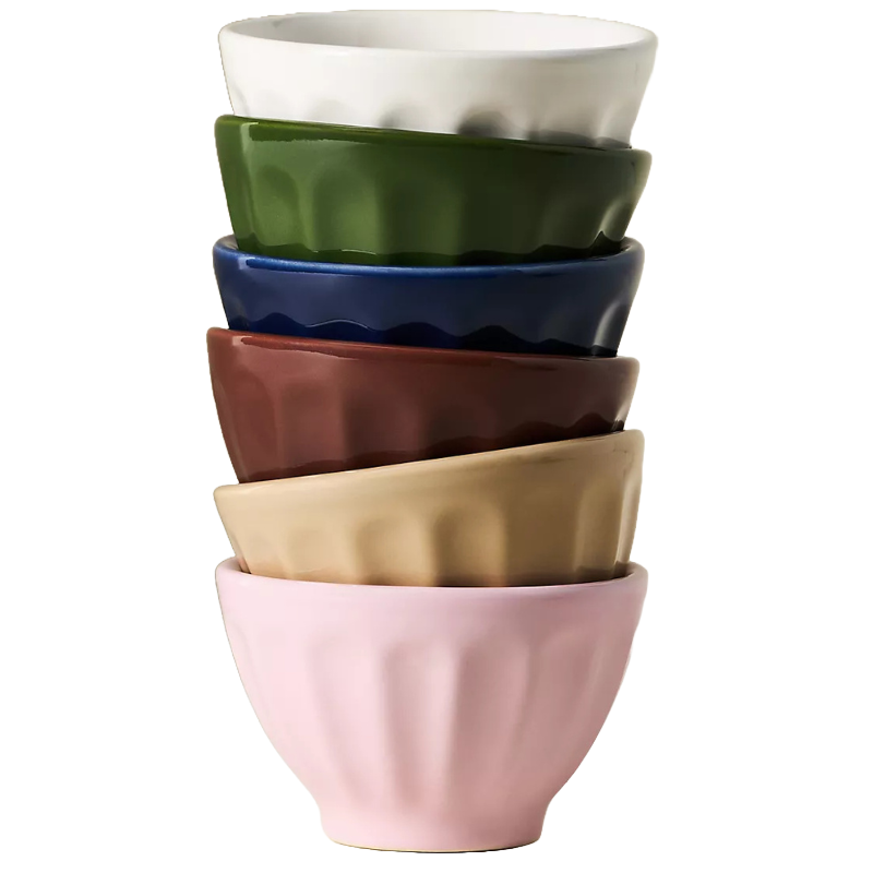 A stack of six ceramic bowls in various colors: white, green, blue, brown, beige, and pink, featuring a textured, fluted design.