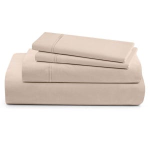 A neatly folded beige bed sheet set includes a fitted sheet, flat sheet, and pillowcases, featuring subtle stitched detailing.