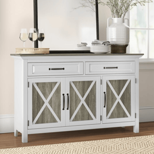 A white 52\“ farmhouse sideboard with two drawers and three cabinet doors featuring an X-pattern design. It has black handles and is topped with glassware and kitchen items, complementing a rustic decor style.