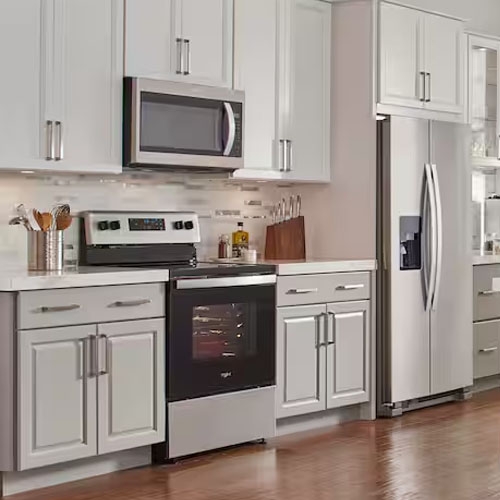A kitchen with light grey cabinets and stainless steel appliances.