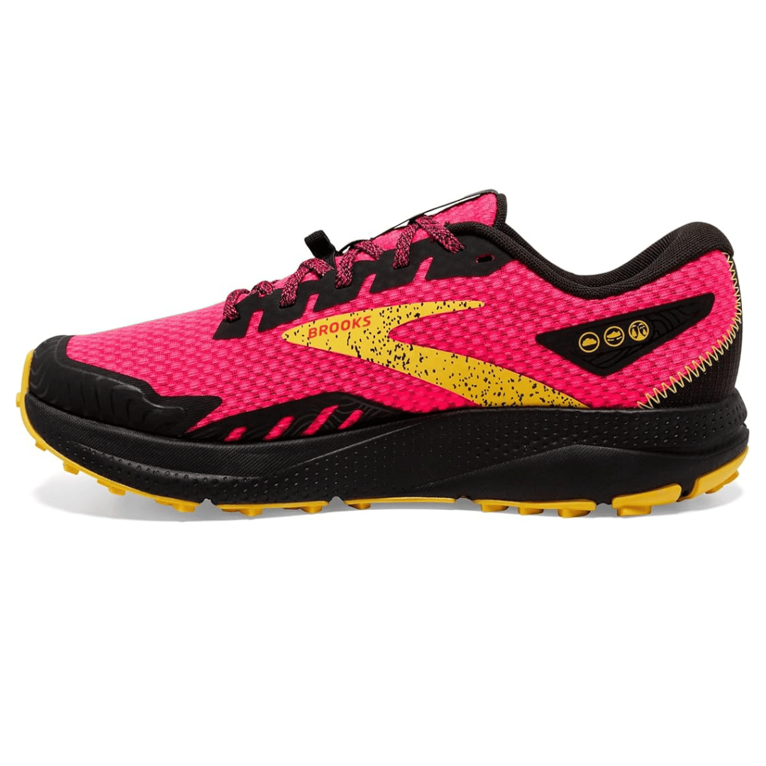 Bright pink and black trail running shoe with yellow accents, featuring a textured mesh upper and rugged sole designed for various terrains.