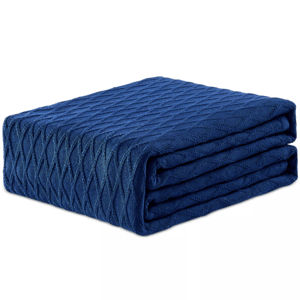 A folded blue blanket with a textured diamond pattern.