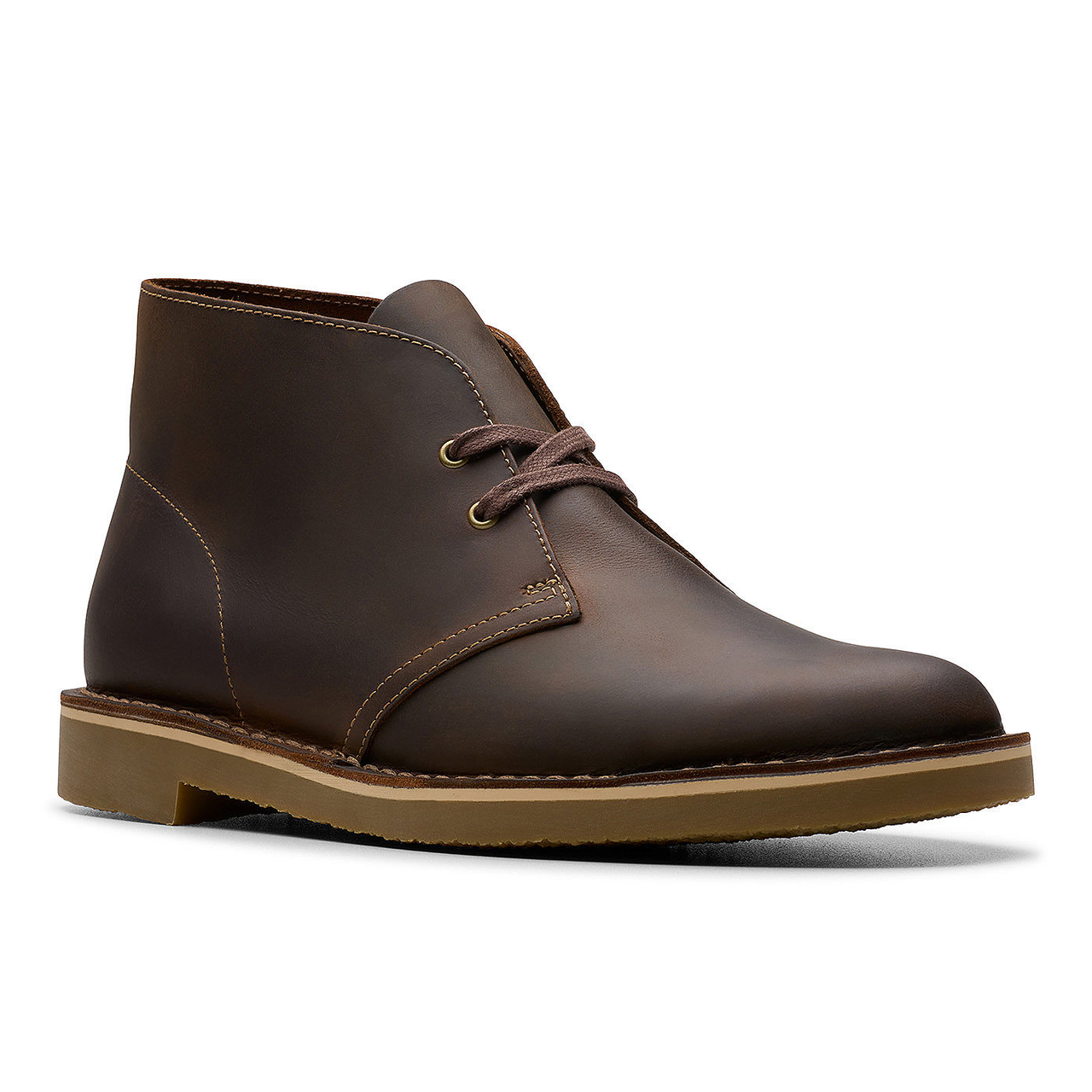 Brown leather chukka boots with matching laces, visible stitching, and a flat, contrasting rubber sole.