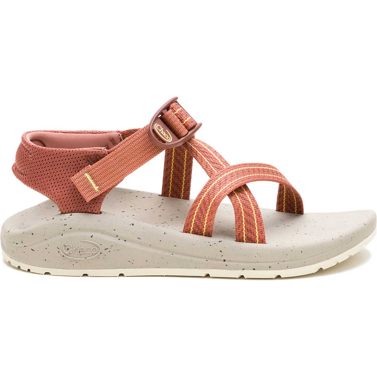 Chaco sandal featuring a textured sole, adjustable straps with a blend of orange and red hues, and a supportive ankle design for comfort and stability.