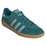 A teal Adidas sneaker featuring suede material, signature three stripes in white, and a brown gum sole.