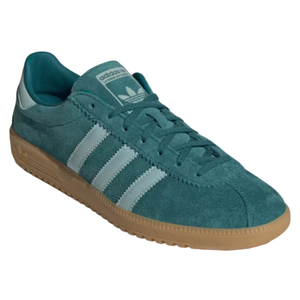 A teal Adidas sneaker featuring suede material, signature three stripes in white, and a brown gum sole.