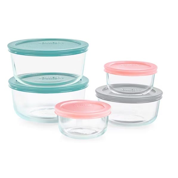 A set of five clear glass food storage containers with colorful lids in teal, pink, and gray.