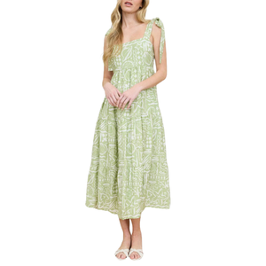 Green sleeveless midi dress with a square neckline and an abstract pattern, featuring tie-up shoulder straps and a tiered skirt.
