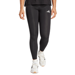 Black leggings and white sneakers with logo details, worn by a person.