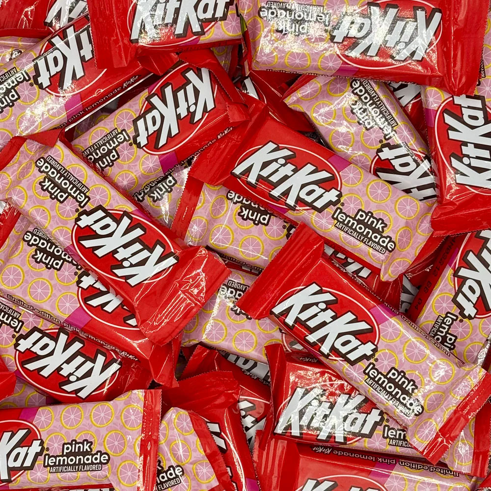 Kit-Kat Pink Lemonade bars are individually wrapped in pink and red packaging, featuring a citrusy print and labeled as artificially flavored.