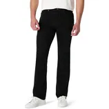 A person wearing black jeans paired with white sneakers and a white shirt, cropped at the waist.