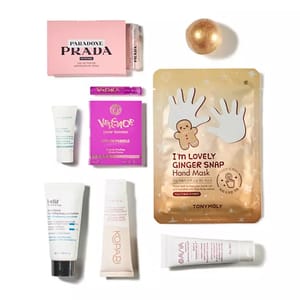 The image contains various beauty and skincare products, including a Prada Paradoxe perfume, Versace perfume samples, a TonyMoly Ginger Snap Hand Mask, and creams from Clarins, Belif, Kopari, and Amala.