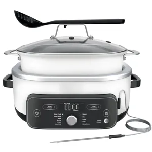 Multi-functional cooker with digital controls featuring modes for slow cooking, searing, baking, and steaming. Includes a glass lid, black ladle, and temperature probe for precise cooking.