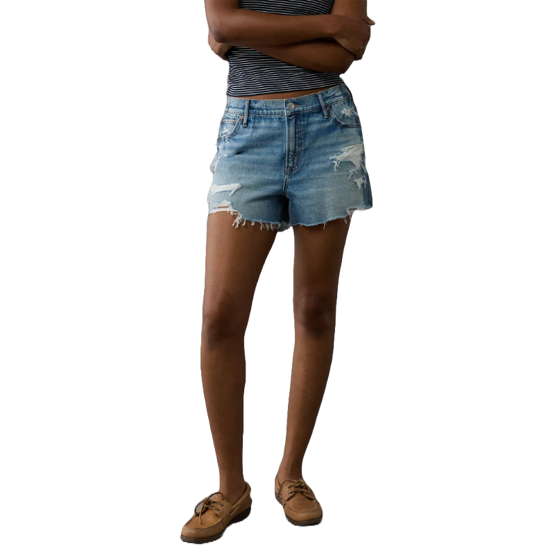 A person is wearing distressed denim shorts, a striped sleeveless top, and brown loafers.