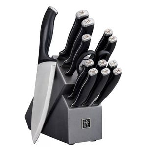 A J.A. Henckels knife set consisting of various knives with black handles inserted neatly into a grey block marked with the Henckels logo.
