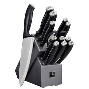 A J.A. Henckels knife set consisting of various knives with black handles inserted neatly into a grey block marked with the Henckels logo.