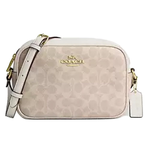 A Coach crossbody bag with a light beige monogram pattern, featuring a gold logo and a matching adjustable strap.