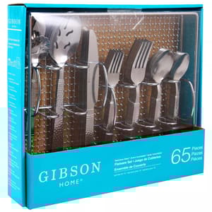 Gibson Home 65-piece stainless steel flatware set for 12, featuring forks, knives, spoons, and serving utensils.