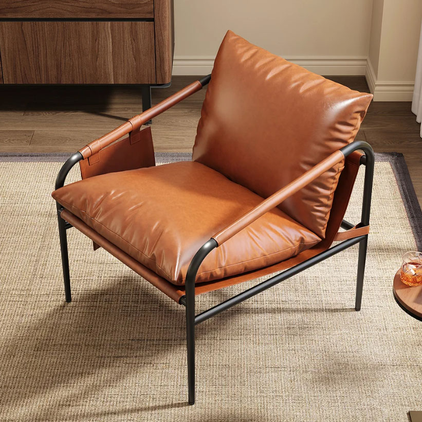 A brown leather lounge chair features a black metal frame and cushioned seat and backrest. It's positioned on a beige textured rug, with a wooden cabinet and a small round side table in the background.