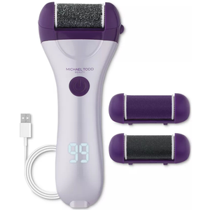 Michael Todd Beauty Smoothing Device is a handheld electric tool for foot care, featuring a digital display, purple and white design, two interchangeable roller heads, and a USB charging cable.
