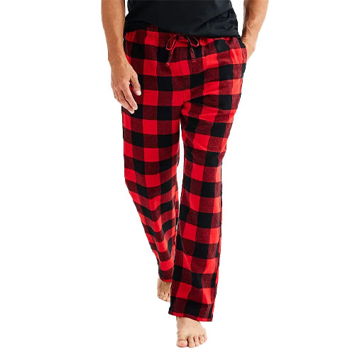 Red and black checkered pajama pants with a drawstring waist, worn by a person standing with bare feet.