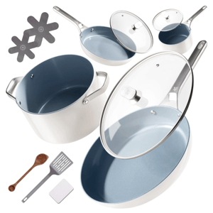 A white cookware set with blue non-stick interiors includes pots, pans with glass lids, a wooden spoon, a spatula, and two protective pads.
