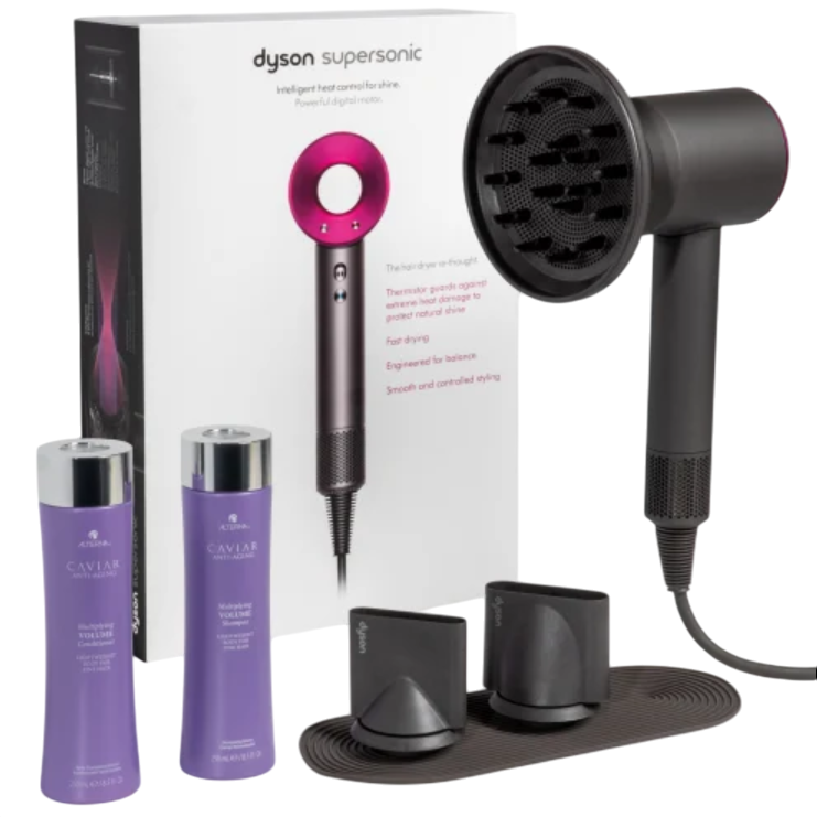 Dyson Supersonic hair dryer with a diffuser and two styling attachments, accompanied by Alterna Caviar Anti-Aging shampoo and conditioner bottles.