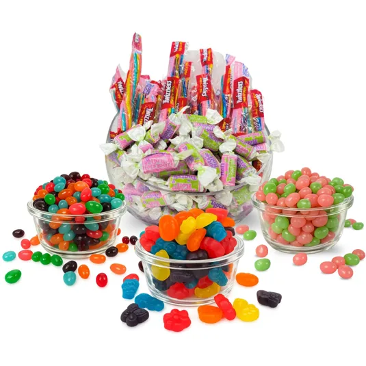 A variety of candies including Tootsie Rolls, wrapped candies, jelly beans, and gummy candies are displayed in clear bowls.