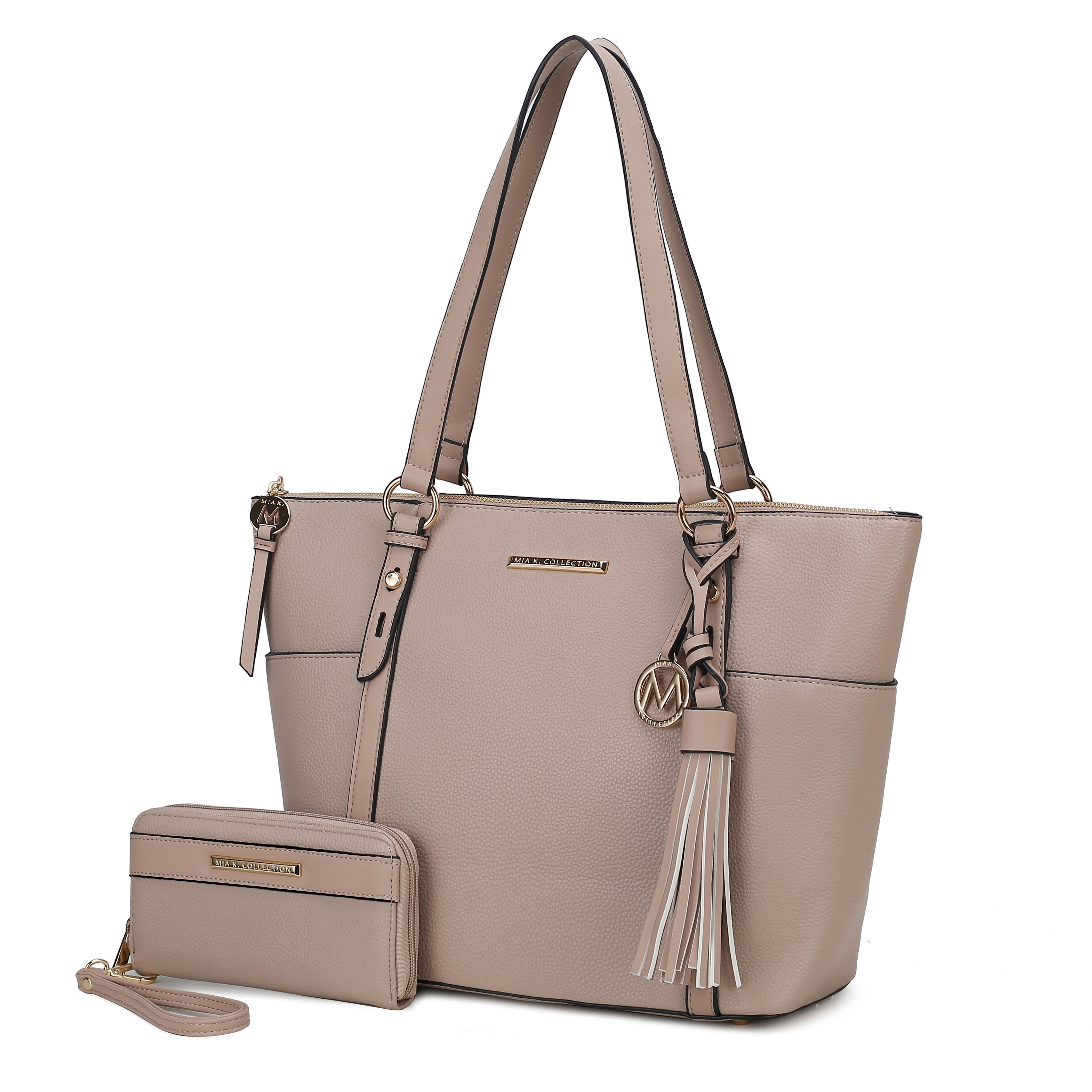 A taupe-colored tote bag with dual handles, tassel detail, and gold accents is paired with a matching zip-around wallet featuring a wrist strap.