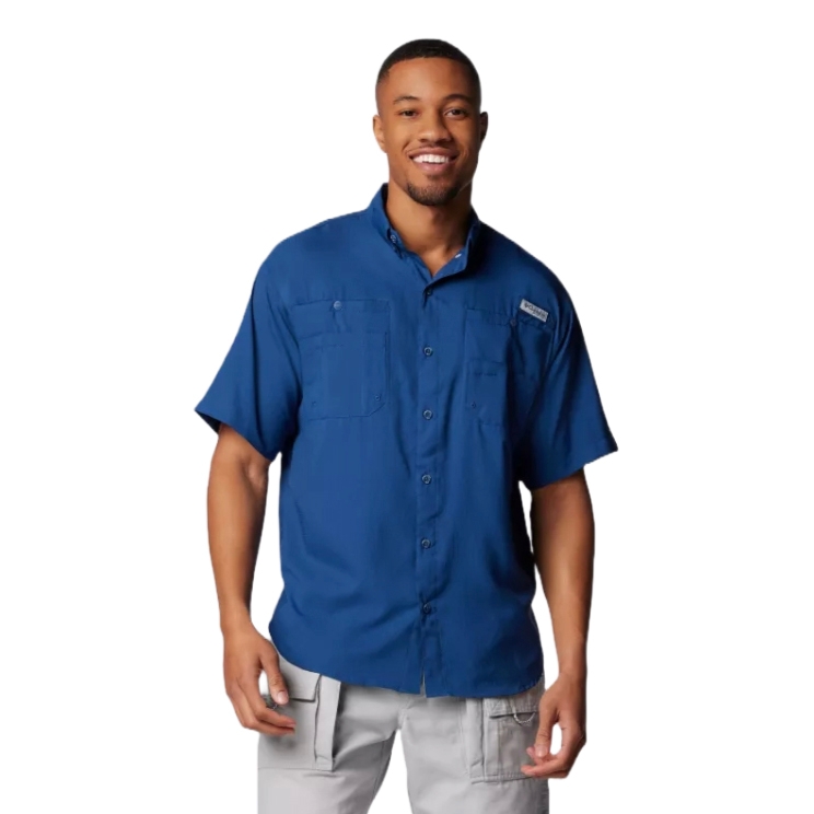 Man wearing a blue short-sleeve button-up shirt with chest pockets and light gray pants.