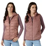 Two models wear reversible vests: one side is quilted, and the other is fluffy. Both are rose-colored, paired with long-sleeve shirts and jeans.
