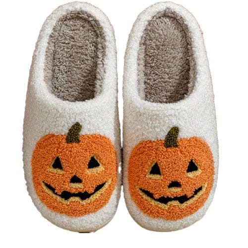 White slippers featuring orange jack-o'-lantern designs.