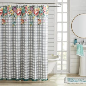 Floral and gingham shower curtain with a scalloped, teal fringe.
