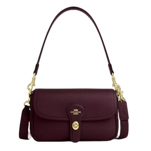 Coach leather shoulder bag in dark burgundy with a pebbled texture, gold-tone hardware, and a detachable strap. It features a front flap closure with a turn-lock mechanism and includes a Coach tag on the side.