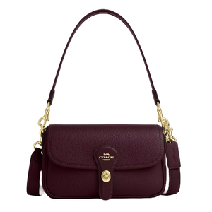 Coach leather shoulder bag in dark burgundy with a pebbled texture, gold-tone hardware, and a detachable strap. It features a front flap closure with a turn-lock mechanism and includes a Coach tag on the side.