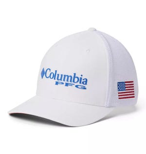 White baseball cap featuring \“Columbia PFG\“ in blue text on the front and a small American flag patch on the side.