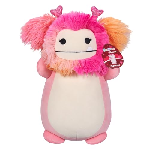 A plush toy resembling a pink Bigfoot with fluffy hot pink hair, tiny pink antlers, and a white belly, standing upright with a friendly face.