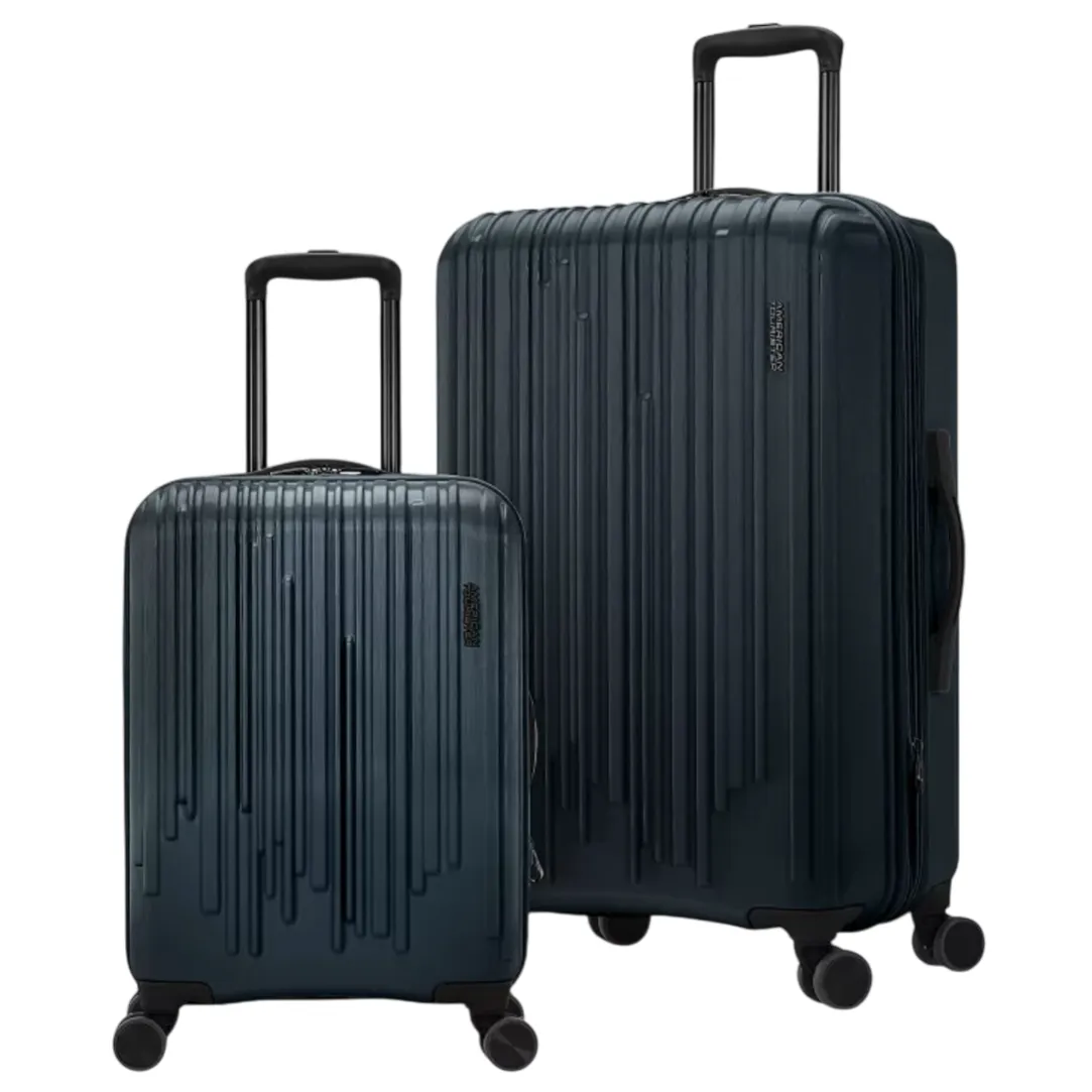 Two dark blue hard-shell suitcases with telescopic handles and spinner wheels, featuring vertical line designs.