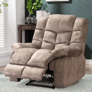 Plush beige recliner with cushioned armrests and an extended footrest, set in a cozy living room with a side table, plant, and framed artwork on a green wall.