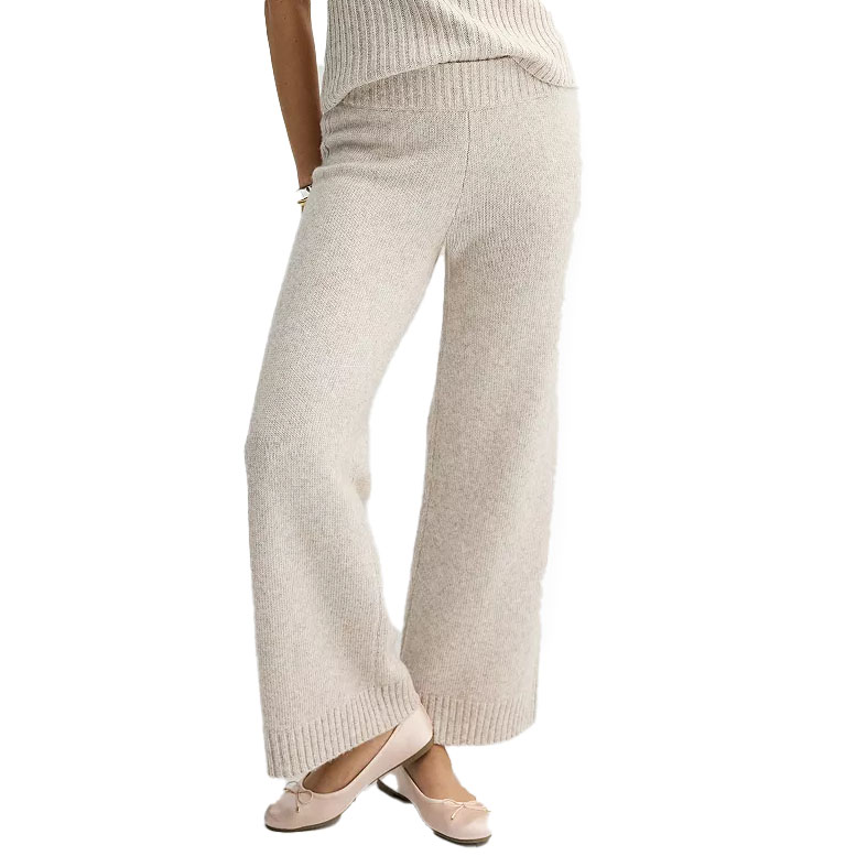 Cream-colored, wide-leg sweater pants made of a soft knit fabric with a ribbed waistband and hem, paired with ballet flats.