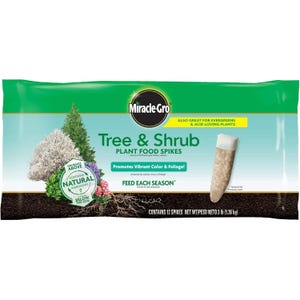 Miracle-Gro Tree & Shrub Plant Food Spikes for evergreens and acid-loving plants, promoting vibrant color and foliage with natural nutrients. Contains 12 spikes, net weight 3 lb (1.36 kg).