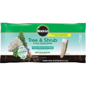 Miracle-Gro Tree & Shrub Plant Food Spikes for evergreens and acid-loving plants, promoting vibrant color and foliage with natural nutrients. Contains 12 spikes, net weight 3 lb (1.36 kg).