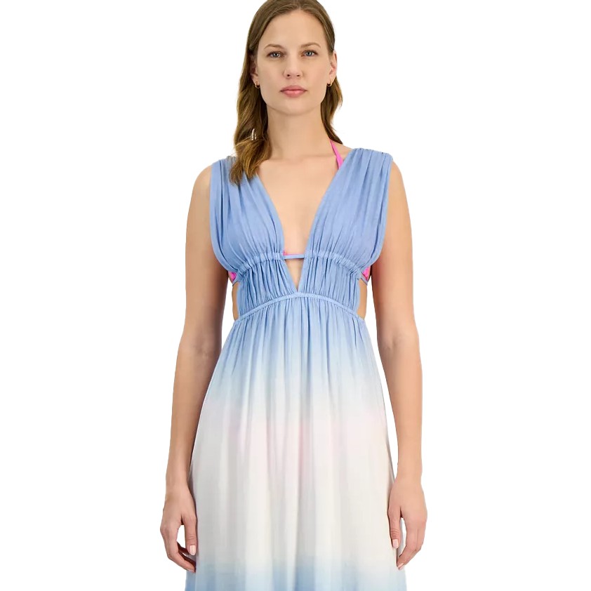 A woman is wearing a sleeveless ombre maxi dress with a deep V-neck. The dress transitions from light blue at the top to white at the bottom. A pink bikini top is visible underneath.