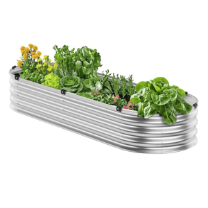A corrugated metal raised garden bed with various plants growing inside, including lettuce, flowers, and other leafy greens.