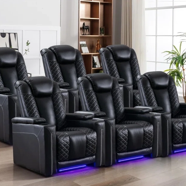 A row of padded black leather recliner chairs with quilted stitching and blue underlighting.