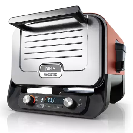 Ninja Woodfire electric grill with a digital display and control knobs, featuring a compact design suitable for indoor use.