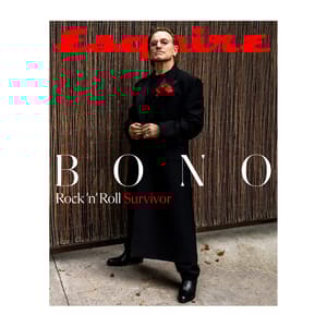 A black-clad figure with a red flower boutonniere stands confidently on the cover of Esquire magazine, featuring the headline \“BONO: Rock 'n' Roll Survivor\“ in contrasting white and red text.