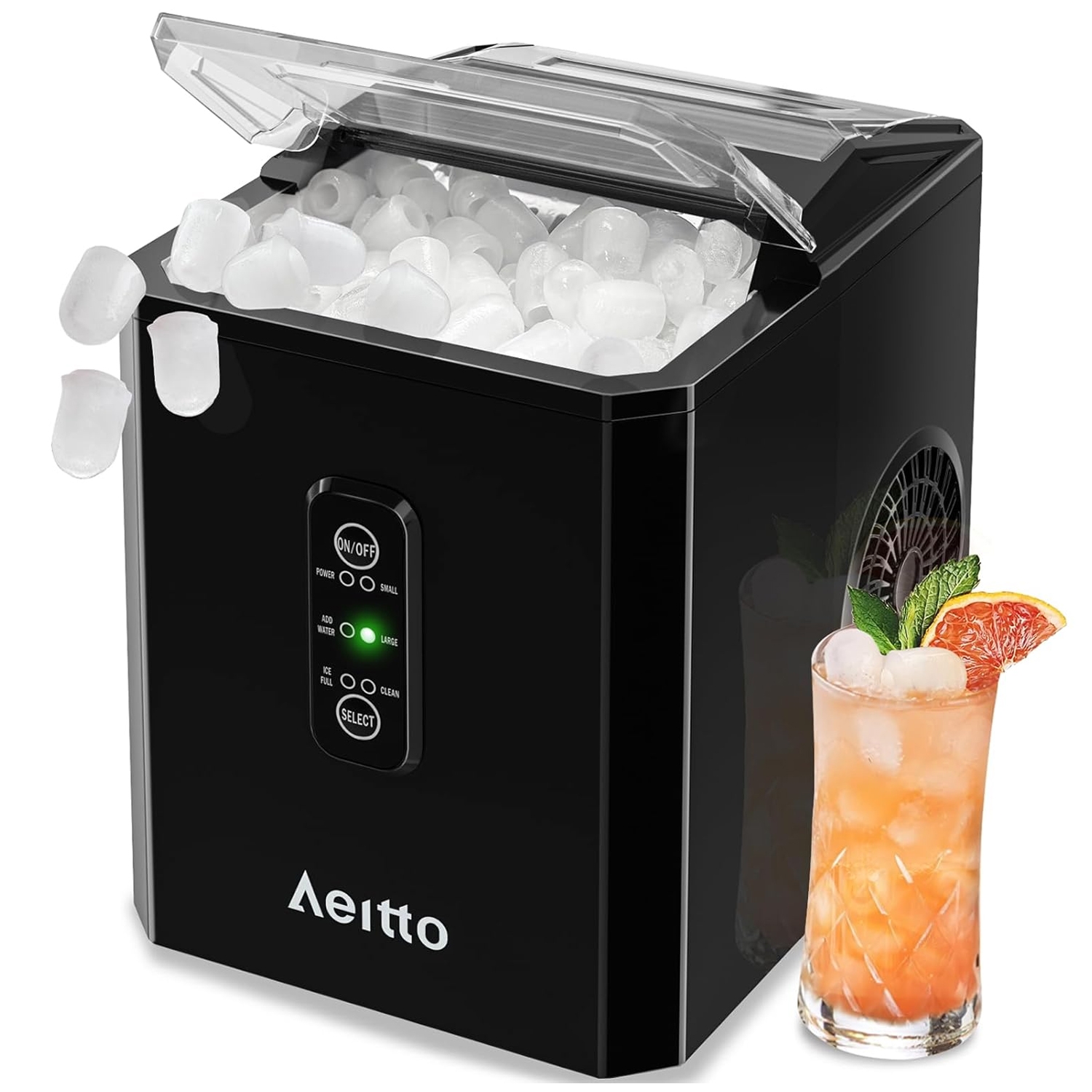 A black, compact 26lb portable ice maker with a transparent lid, shown dispensing clear ice cubes into a container. It has a control panel with an on/off button, size options, and status indicators. A glass of iced drink is placed beside it.