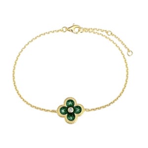 Gold bracelet with a clover-shaped green gemstone pendant featuring a central diamond, and a lobster clasp closure.